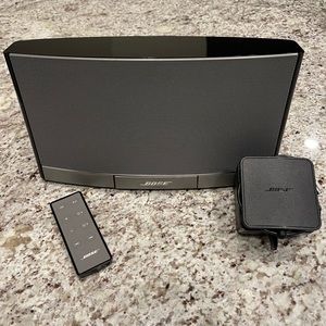 Bose SoundDock portable speaker with charger and remote + Bluetooth adapter.